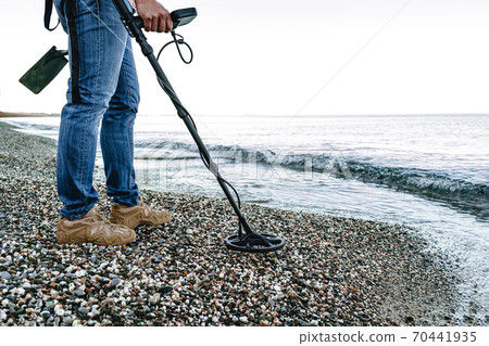 Metal detector coil in action above the ground Metal detector coil in action above the ground 70441935