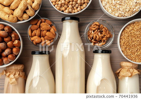 Concept of organic vegan non dairy milk with glass milk bottle and bulk products Concept of organic vegan non dairy milk with glass milk bottle and bulk products 70441936
