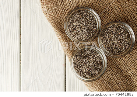 Glass bowl with chia seeds on wooden table Glass bowl with chia seeds on wooden table 70441992