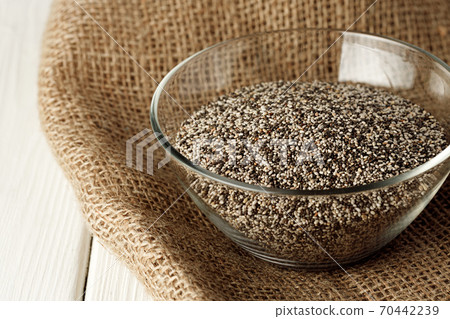 Glass bowl with chia seeds on wooden table Glass bowl with chia seeds on wooden table 70442239