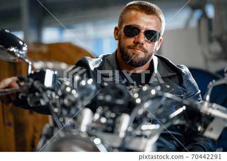 Portrait of motorbike rider in black leather outfit Portrait of motorbike rider in black leather outfit 70442291
