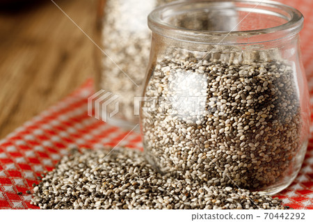 Glass bowl with chia seeds on wooden table Glass bowl with chia seeds on wooden table 70442292