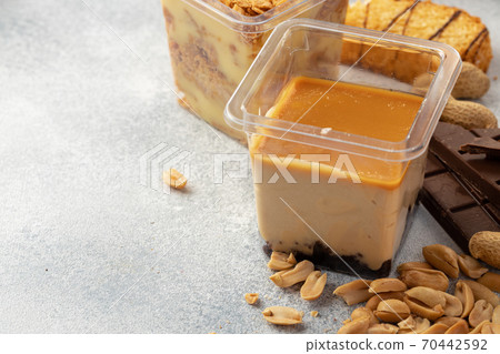 Brown mousse cream dessert in plastic transparent box on grey surface Brown mousse cream dessert in plastic transparent box on grey surface 70442592