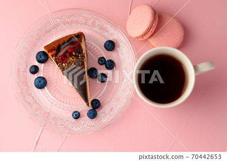 Piece of cheesecake with chocolate top and berries Piece of cheesecake with chocolate top and berries 70442653