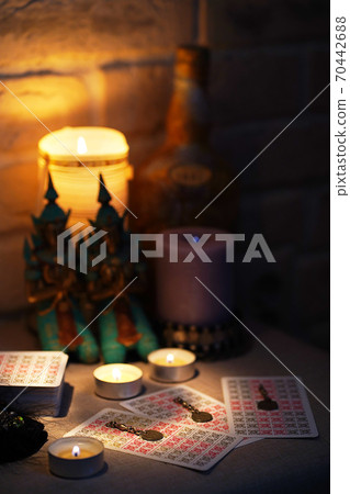 Fortune-telling on tarot cards on the table with a candle Fortune-telling on tarot cards on the table with a candle 70442688