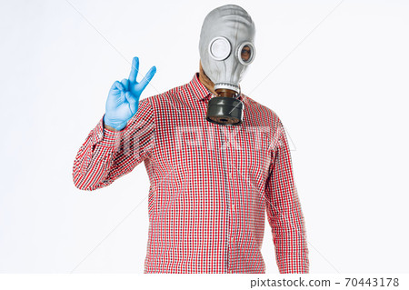 Portrait of a man in a gas mask. Panic during quarantine. Coronavirus pandemia Portrait of a man in a gas mask. Panic during quarantine. Coronavirus pandemia 70443178