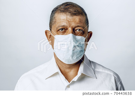 Portrait of a sick adult man in medical mask. Coronavirus pandemia concept Portrait of a sick adult man in medical mask. Coronavirus pandemia concept 70443638
