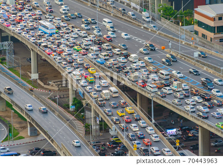 Aerial view of busy cars with traffic jam in the rush hour on highway road street on bridge in Bangkok Downtown, urban city in Asia, Thailand at sunset. Intersection junction. Toll gate in Rama 9 70443963