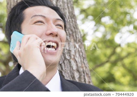 A businessman calling on a smartphone A businessman calling on a smartphone 70444920