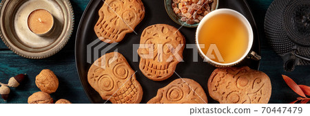 Halloween ginger cookies in the shape of skulls, panorama, homemade Dia de los muertos biscuits, shot from the top Halloween ginger cookies in the shape of skulls, panorama, homemade Dia de los muertos biscuits, shot from the top 70447479