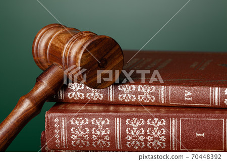 Close up of a brown wooden gavel and book 70448392