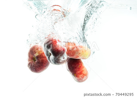 Bunch of doughnut peaches isolated on white, splashing into water. Bunch of doughnut peaches isolated on white, splashing into water. 70449295