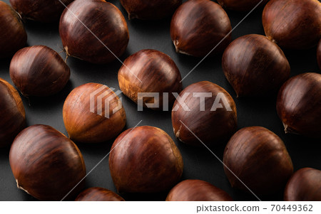 Rows of chestnuts isolated on black background 70449362