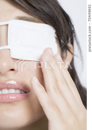 Woman with an eyepatch 70449691