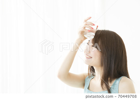 A woman drinking water 70449708
