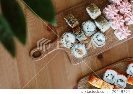 Japanese kitchen rolls on a wooden background, home delivery 70449764