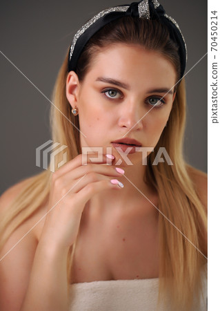 Close up portrait of sexy blond young woman sitting at table, hoop on her head Close up portrait of sexy blond young woman sitting at table, hoop on her head 70450214