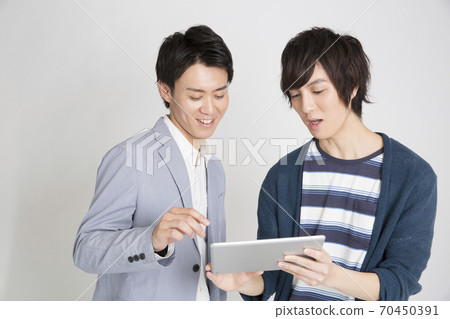 A man watching a tablet PC A man watching a tablet PC 70450391