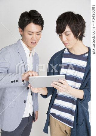 A man watching a tablet PC A man watching a tablet PC 70450395