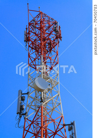 Mobile phone communication antenna tower with satellite dish on blue sky background Mobile phone communication antenna tower with satellite dish on blue sky background 70450783