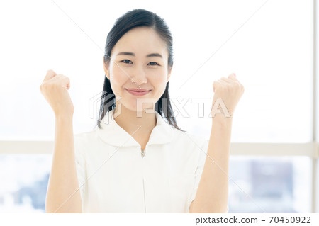 Female nurse doing a guts pose [Portrait] 70450922