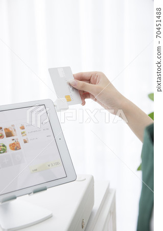 Female clerk making card payment Female clerk making card payment 70451488