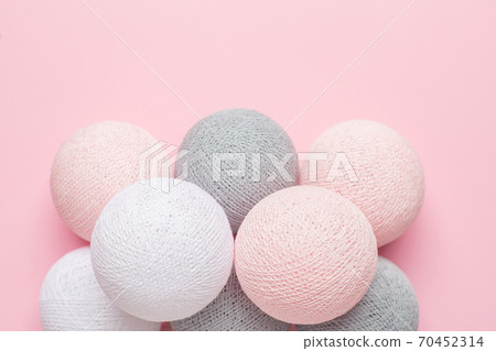 Pink, grey and white balls on a pastel background Pink, grey and white balls on a pastel background 70452314