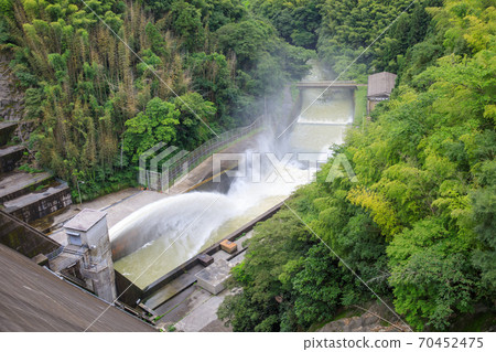 Ishidekawa dam that discharges water 70452475