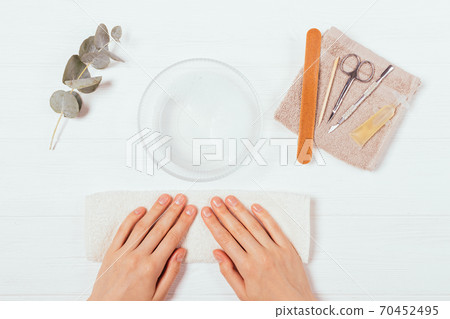 Female hands next to set of tools and beauty products 70452495