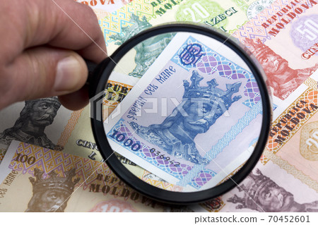 Moldovan leu in a magnifying glass 70452601