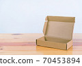 Empty brown cardboard box on wooden table with copy space. 70453894