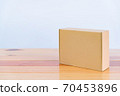 Empty brown cardboard box on wooden table with copy space. 70453896