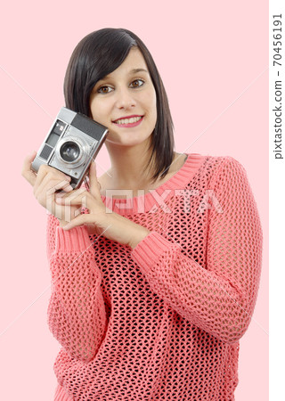 pretty young brunette woman with antique camera 70456191