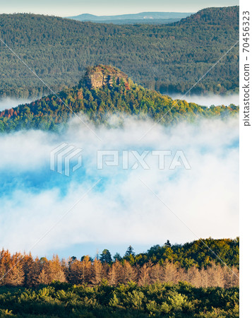 Zirkelstein shinning above mist. Sandstone block 70456323