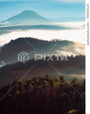 Colorful fog in the mountain valley. Landscape with forests 70456324
