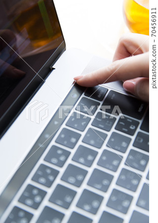 Woman operating a personal computer 70456911