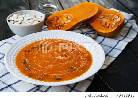 Homemade pumpkin soup on a black table Homemade pumpkin soup on a black table 70458983