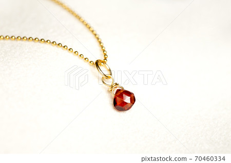 Red tea stone and gold chain necklace and white back 70460334