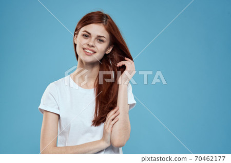 pretty woman white tshirt long hair glamor lifestyle cropped view blue background pretty woman white tshirt long hair glamor lifestyle cropped view blue background 70462177