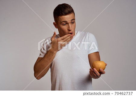 A man with an orange and a white t-shirt on a light background cropped view of the model 70462737