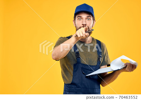 Man in working form documents transportation delivery service yellow background Man in working form documents transportation delivery service yellow background 70463552