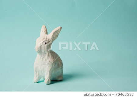Festive white rabbit toy on a blue background with pastel colors Easter Festive white rabbit toy on a blue background with pastel colors Easter 70463553