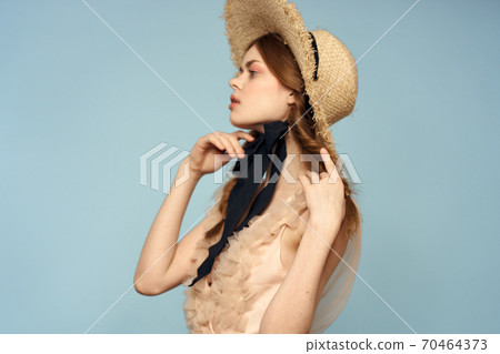 Romantic girl in a straw hat on a gray background and a beige sundress black ribbon emotions model 70464373
