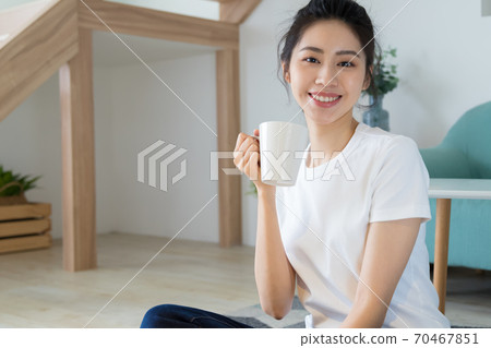 Beautiful woman enjoying coffee at home 70467851