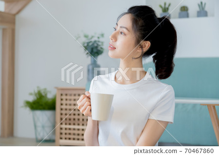 Beautiful woman enjoying coffee at home Beautiful woman enjoying coffee at home 70467860