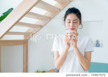 Beautiful woman enjoying coffee at home 70467870