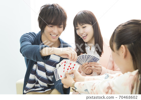 Men and women playing cards 70468602