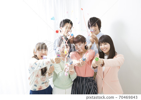 Men and women celebrating with crackers Men and women celebrating with crackers 70469843