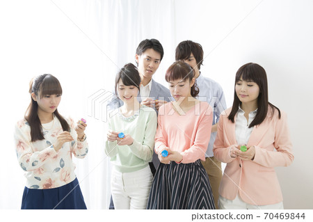Men and women celebrating with crackers 70469844
