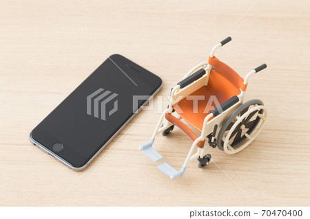 A smartphone and a wheelchair A smartphone and a wheelchair 70470400